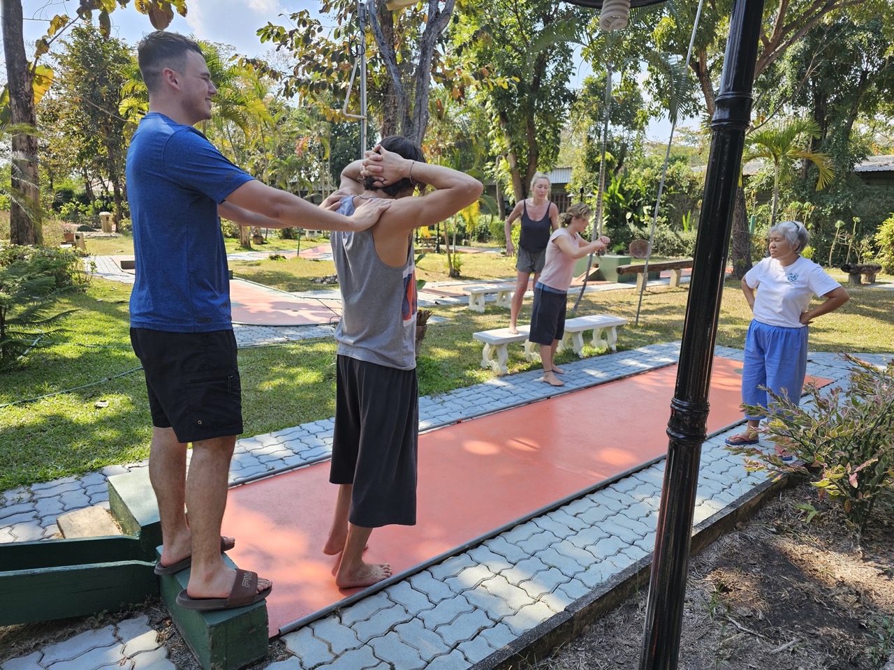 Guests practising movement outdoors in the resort garden