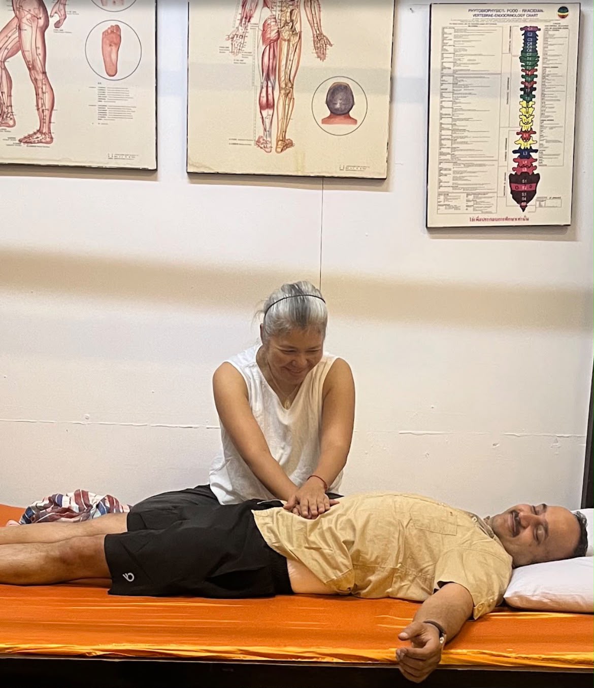 Dr. Sirichan performing abdominal Thai massage in Chiang Mai